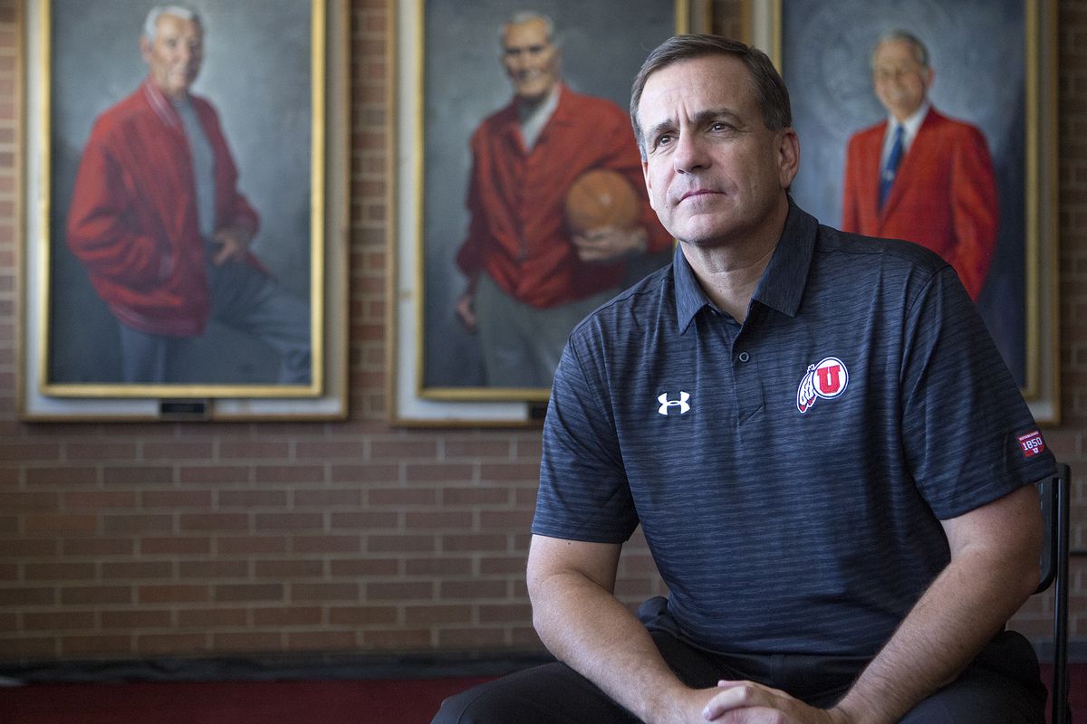 Mark Harlan, the new athletic director at the University of Utah, poses in front of portraits of former athletic director Isaac Armstrong, left, former head basketball coach Vadal Peterson and former athletic director James Jack at the Huntsman Center in Salt Lake City on Friday, June 29, 2018.
