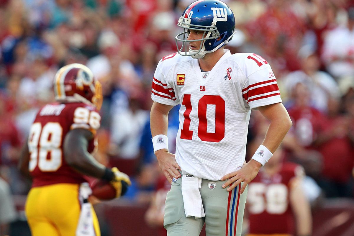 LANDOVER, MD - SEPTEMBER 11:   Eli Manning #10 of the New York Giants walks off the field during the season opener against the Washington Redskins at FedExField on September 11, 2011 in Landover, Maryland.  (Photo by Ronald Martinez/Getty Images)