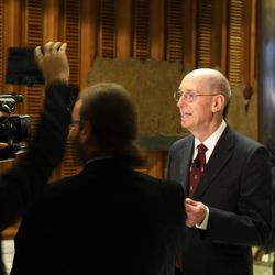 President Henry B. Eyring talks with press in the foyer of Synod Hall.