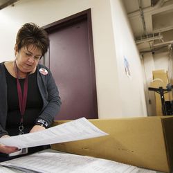 Salt Lake County Elections Director Rozan Mitchell inspects the write-in section on various ballots at the Salt Lake County Government Center in Salt Lake City, Friday, Oct. 21, 2016. Mitchell has filed to run against her boss, Salt Lake County Clerk Sherrie Swensen.