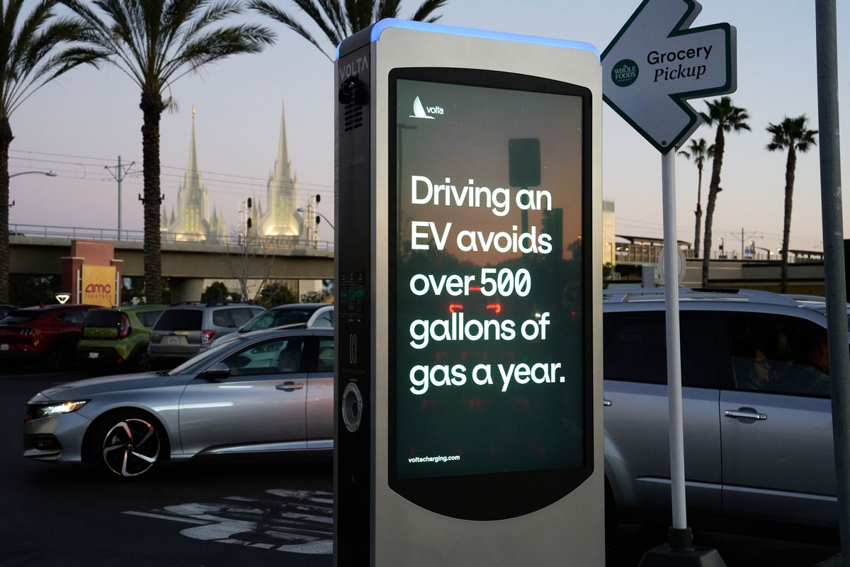 A Volta electric vehicle charger in the La Jolla neighborhood of San Diego, California, on January 27, 2023, displays a screen that reads, “Driving an EV avoids over 500 gallons of gas a year.”
