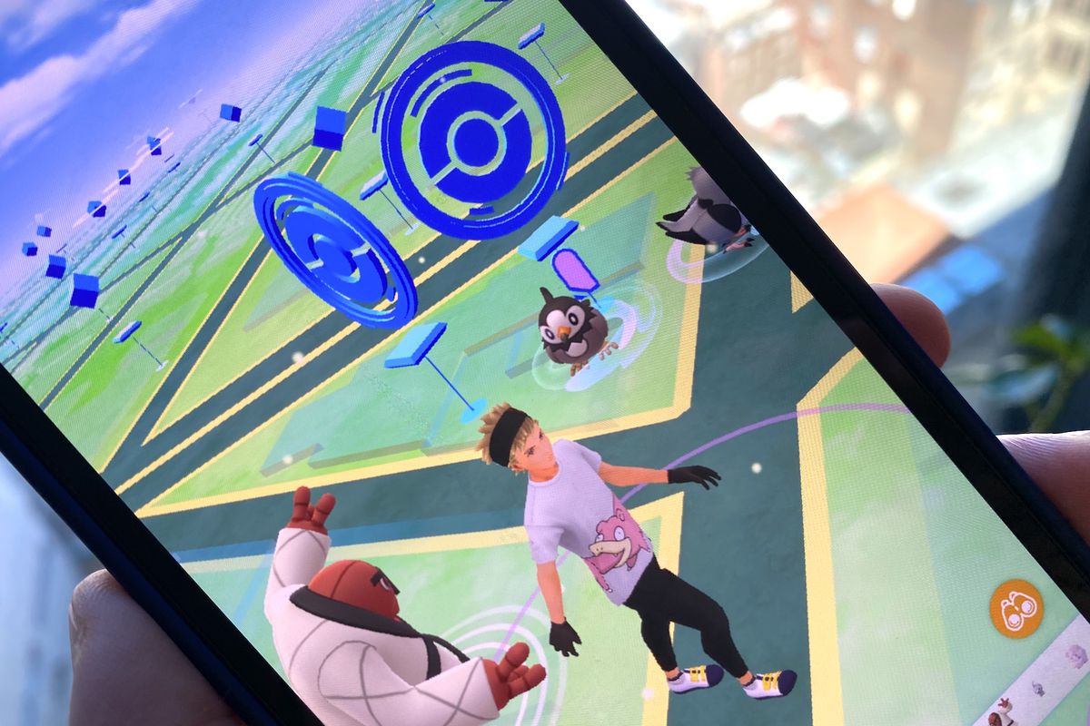 A trainer walks near Pokestops in a photo of Pokémon Go running on an iPhone