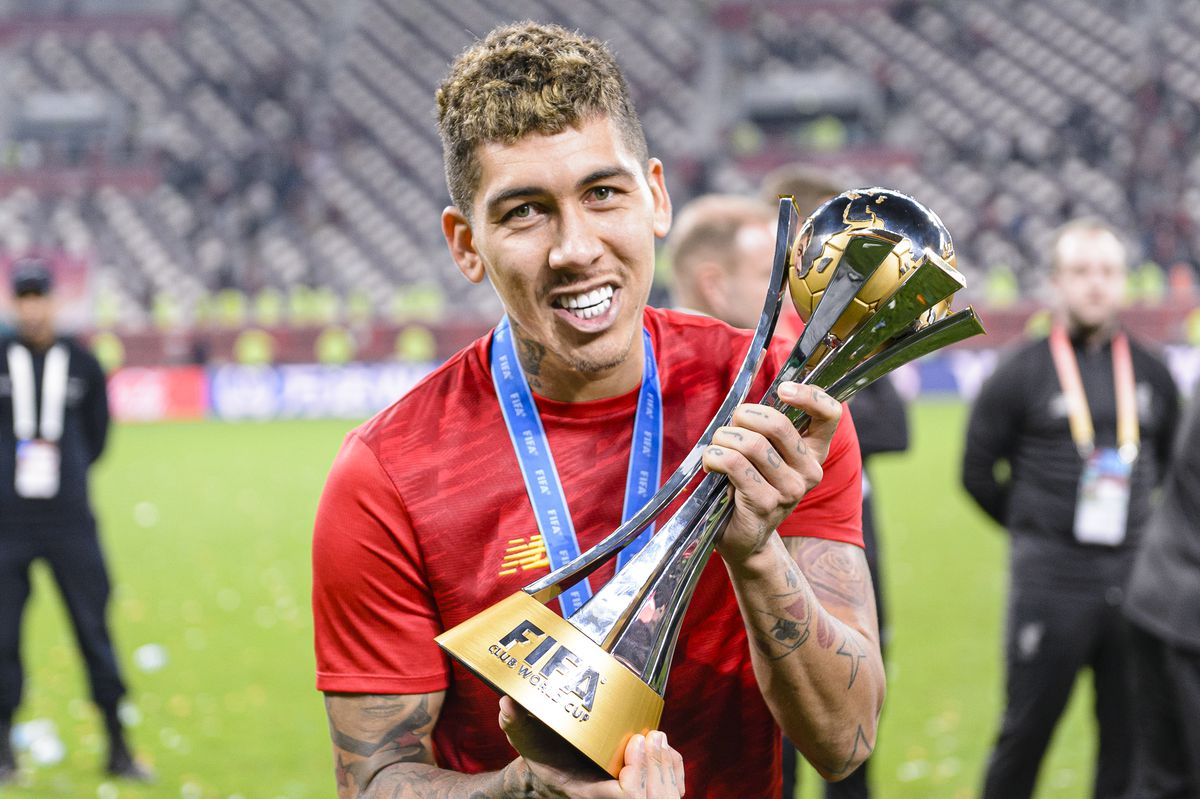 Roberto Firmino poses with the Club World Cup trophy after his goal in extra time won Liverpool their first in the competition on December 21, 2019.