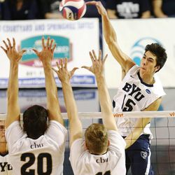 BYU's Brenden Sander spikes the ball past CBU's Enrique de Diego Garcia and Zachary Melcher as BYU and Cal Baptist University play Saturday, Feb. 7, 2015, at BYU in the Smith Field House in Provo.
