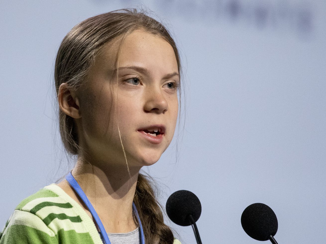 Greta Thunberg speaks into a microphone.