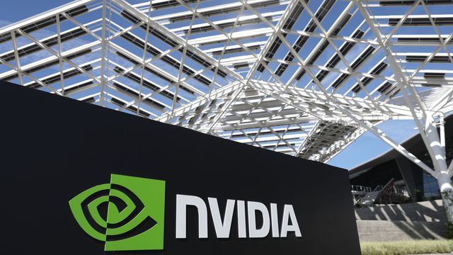 An image of an Nvidia sign in front of a white structure made of metal bars. 