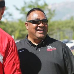 Director Alema Te'o talks with Wisconsin coach Gary Andersen as players work out during All-Poly Camp in Layton Thursday, June 20, 2013.