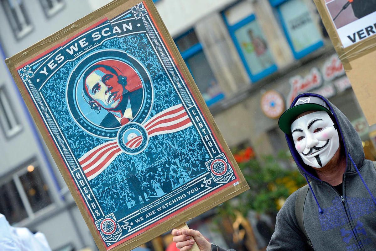 In this picture, taken Saturday June 29, 2013, a  demonstrator protests with a poster against NSA  in Hanover, Germany.  Germany's top justice official says reports that U.S. intelligence bugged European Union offices remind her of "the methods used by en