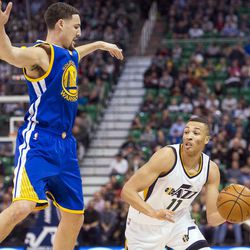 Utah guard Dante Exum (11) drives past Golden State guard Klay Thompson (11) during the first half of an NBA basketball game in Salt Lake City on Thursday, Dec. 8, 2016.