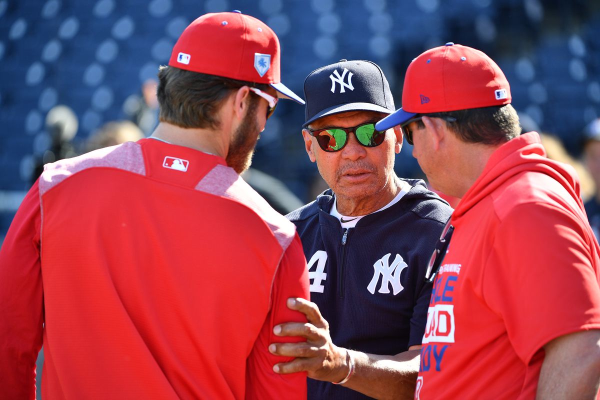 Bryce Harper #3 of the Philadelphia Phillies speaks with Reggie Jackson of the New York Yankees before the spring training game against the New York Yankees at Steinbrenner Field on March 13, 2019 in Tampa, Florida.