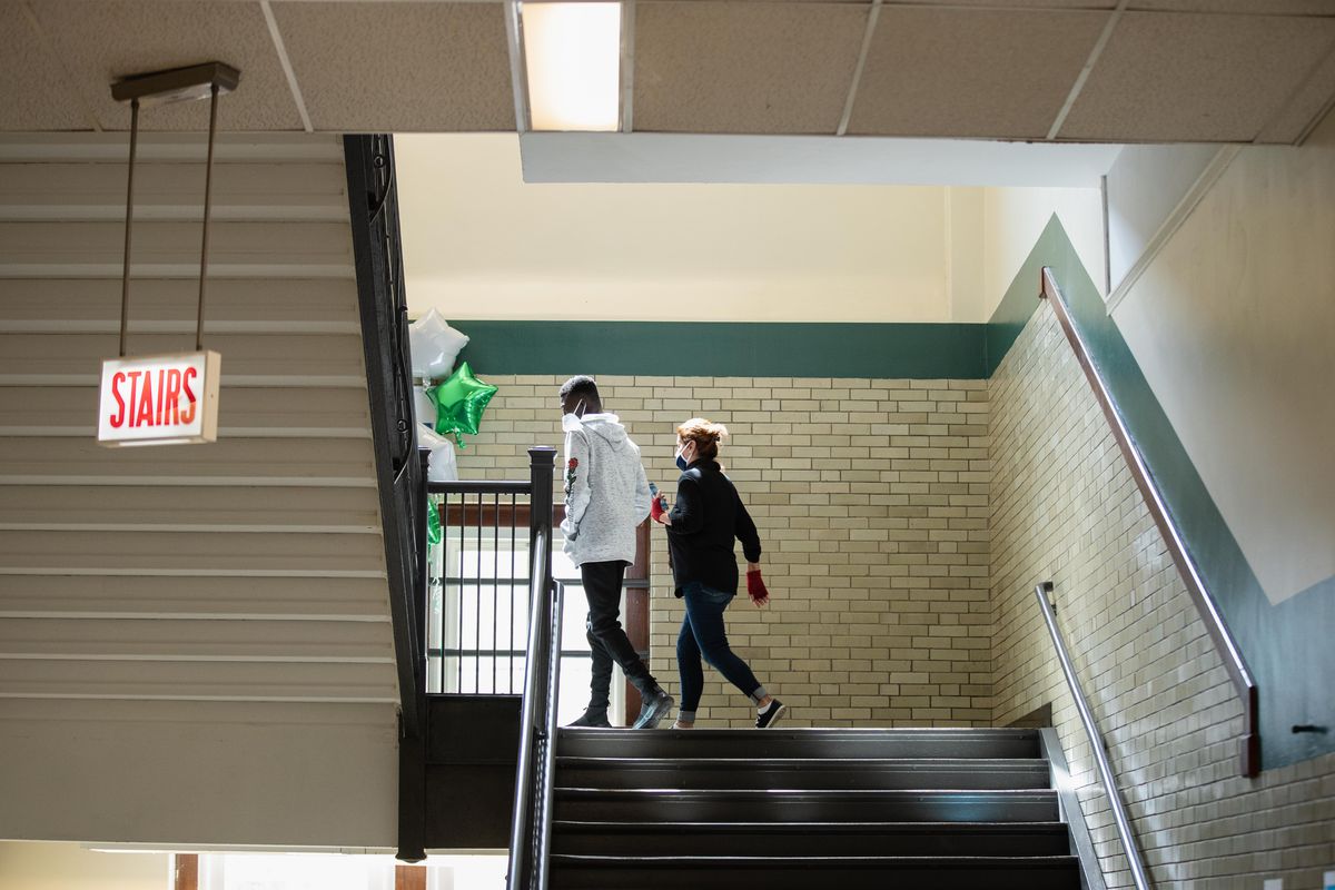 People climb the stairs at Nicholas Senn High School in the Edgewater neighborhood, Friday afternoon, April 23, 2021.