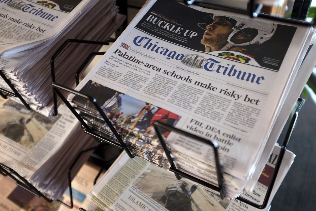 In this Monday, April 25, 2016, file photo, Chicago Tribune and other newspapers are displayed at Chicago’s O’Hare International Airport, in Chicago. A group of alternative bidders is emerging, in late March 2021, for newspaper chain Tribune Publishing, which had agreed to a $630 million deal with hedge fund Alden Global Capital.