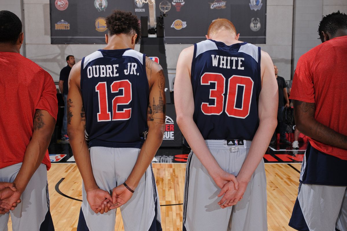LAS VEGAS, NV - JULY 12: Kelly Oubre Jr. #12 and Aaron White #30 of the Washington Wizards stand on the court during the National Anthem before the game against the D-League Selects on July 12, 2015 at the Cox Pavilion in Las Vegas, Nevada.