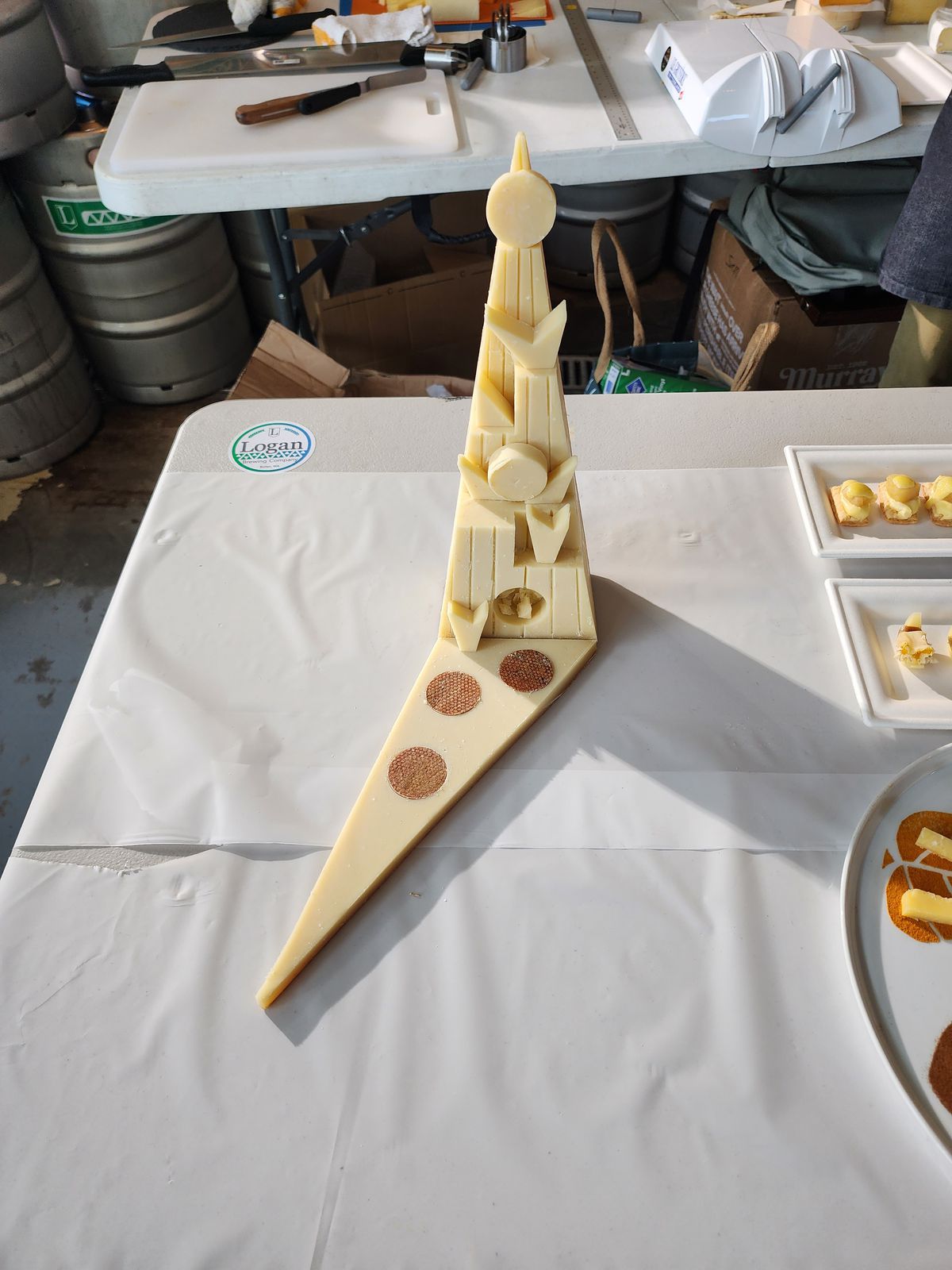 A small cheese sculpture sits on a white table.