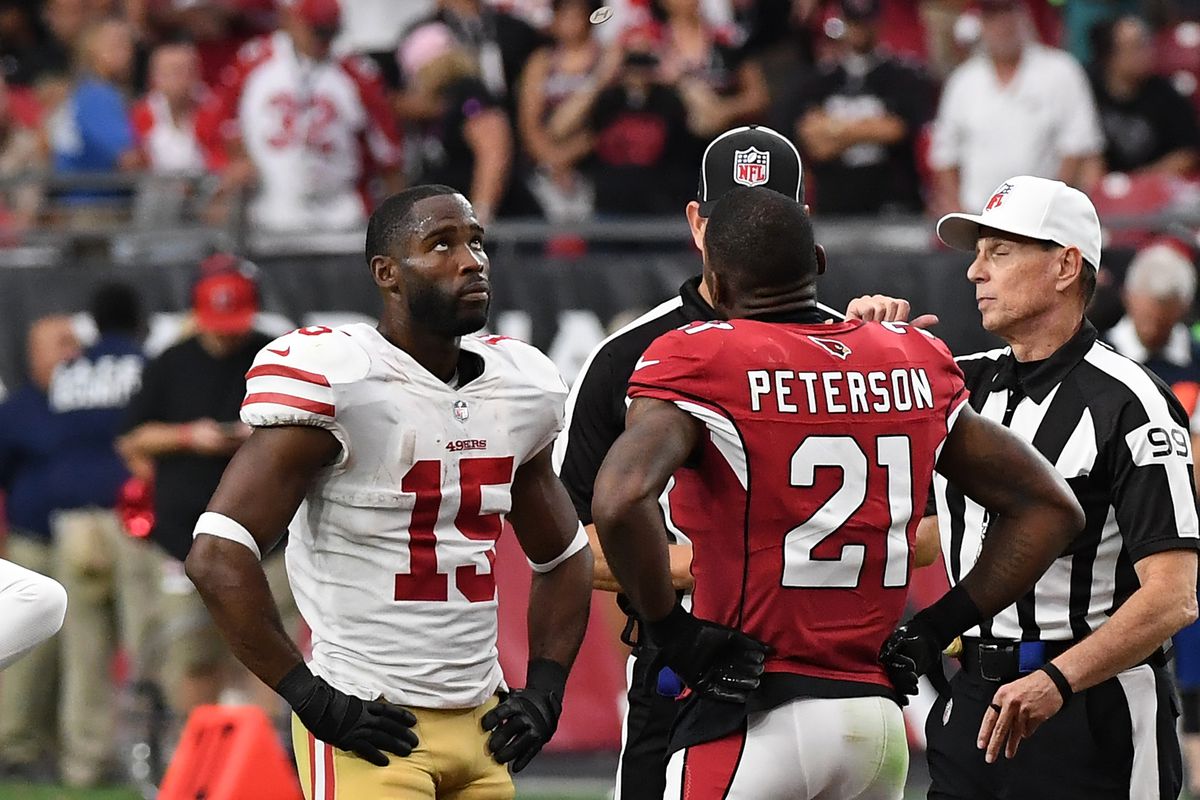 Patrick Peterson #21 of the Arizona Cardinals and Pierre Garcon #15 of the San Francisco 49ers meet at midfield at the start of overtime for the coin flip by referee Tony Corrente #99 at University of Phoenix Stadium on October 1, 2017 in Glendale, Arizona.