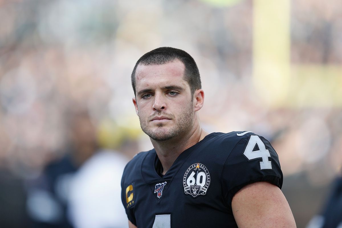 Derek Carr #4 of the Oakland Raiders talks to teammates on the bench in the first half against the Tennessee Titans at RingCentral Coliseum on December 08, 2019 in Oakland, California.