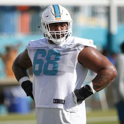 Miami Dolphins offensive guard Isaac Asiata prepares to run drills during an NFL football training camp, Thursday, July 27, 2017 at the Dolphins training facility in Davie, Fla.