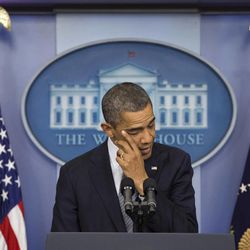 President Barack Obama wipes his eye as he talks about the Connecticut elementary school shooting, Friday, Dec. 14, 2012, in the White House briefing room in Washington. 