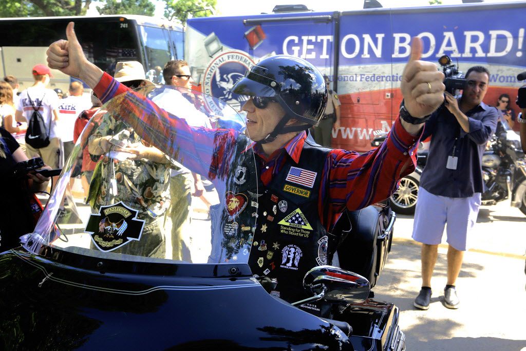Gov. Bruce Rauner arrives on his motorcycle to participate in a Republican rally during Governors Day at the Illinois State Fair Wednesday, Aug. 17, 2016, in Springfield, Ill. (AP Photo/Seth Perlman)