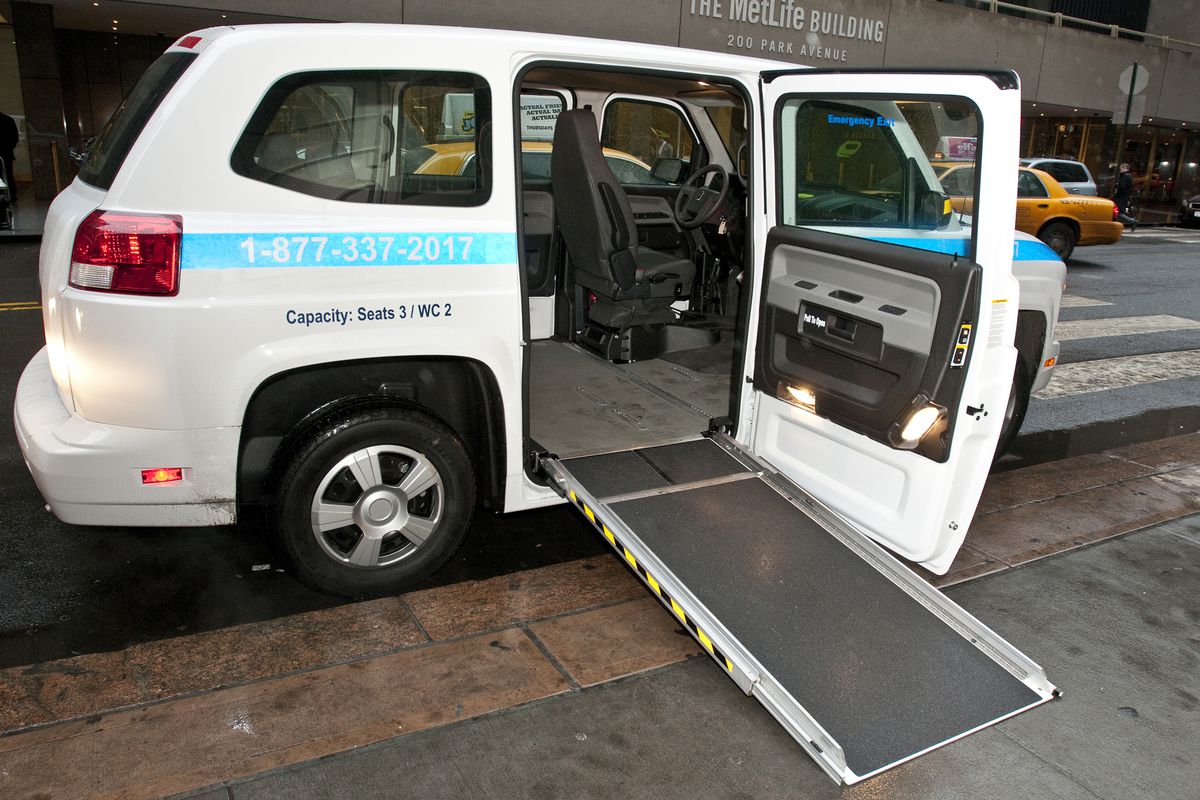 A wheelchair accessible van in New York with ramp extended.