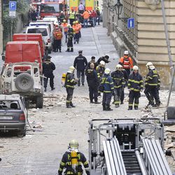 Firefighters and rescue workers work at the scene of a strong blast in a building in the center of Prague, Czech Republic, in the morning on Monday, April 29, 2013.  A powerful explosion badly damaged an office building in the center of the Czech capital Monday, injuring up to 40 people. Authorities believe people may still be buried in the rubble.  (AP Photo/CTK, Michal Dolezal)