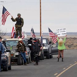 FILE - In this Feb. 11, 2016 file photo, authorities and demonstrators wait at the Narrows roadblock near the Malheur National Wildlife Refuge near Burns, Ore. Dozens of armed occupiers who took over a national wildlife refuge in Oregon have been indicted on additional charges. An indictment unsealed Wednesday, March 9, reveals new counts against group leader Ammon Bundy and more than two dozen other defendants who were indicted last month on a federal conspiracy charge. 