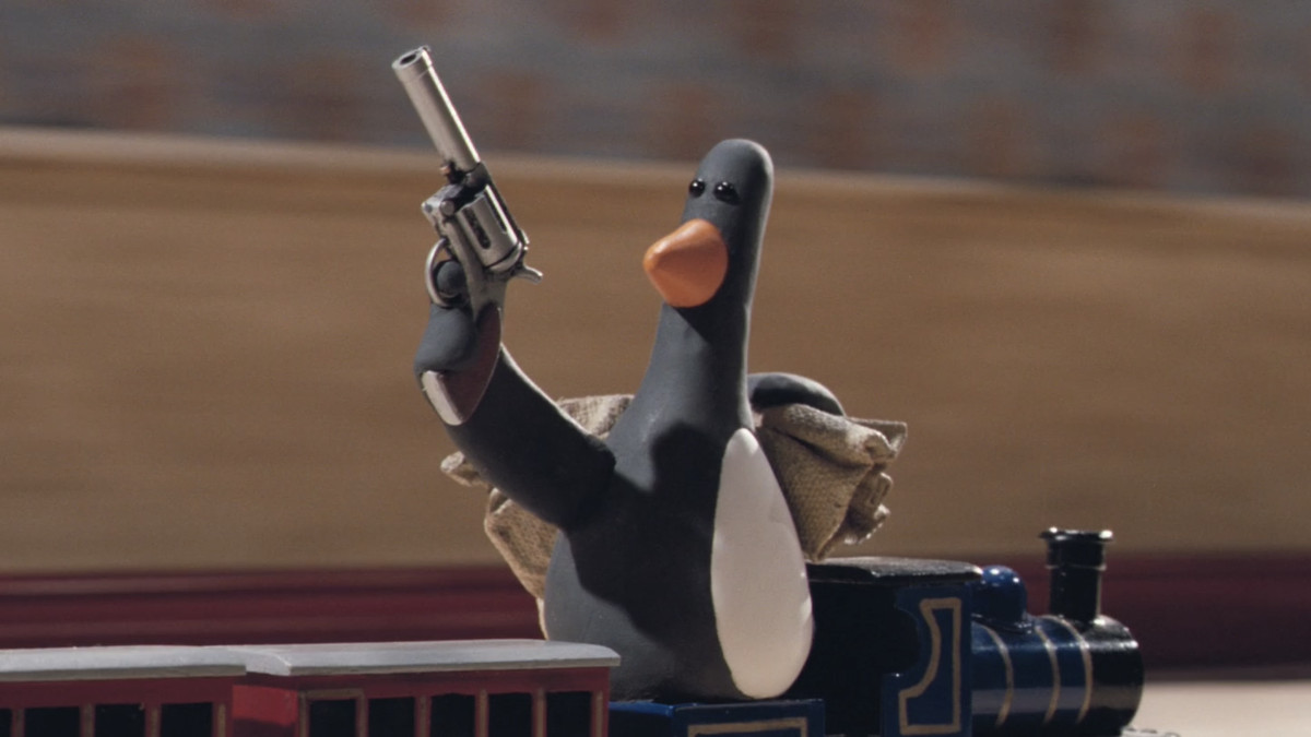 a penguin wielding a gun and riding a toy train in The Wrong Trousers