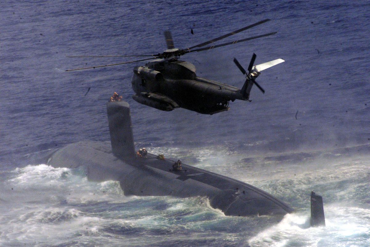 Members Of A U S Navy Seal Team Fast Rope Onto A Navy Submarine During Joint Training Wi