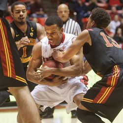 Utah's Glen Dean is stopped by USC's Chass Bryan as Utah and USC play Saturday, Jan. 12, 2013 in the Hunstman Center.