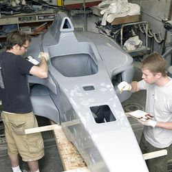 BYU mechanical engineering students Kenny Mix, left, and Ben Dennos prepare a car for its final coat of paint. It was part of a multi-university project.