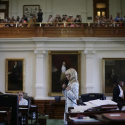 Sen. Wendy Davis, D-Fort Worth, cener, filibusters in an effort to kill an abortion bill, Tuesday, June 25, 2013, in Austin, Texas. The bill would ban abortion after 20 weeks of pregnancy and force many clinics that perform the procedure to upgrade their facilities and be classified as ambulatory surgical centers.  (AP Photo/Eric Gay)