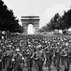 U.S. soldiers of Pennsylvania's 28th Infantry Division march along the Champs Elysees, the Arc de Triomphe in the background, on  Aug. 29, 1944, four days after the liberation of Paris, France. World War II began in September 1939 with Adolf Hitler's invasion of Poland. He launched the Holocaust and history's most destructive war, leaving 17,000,000 soldiers and 60,000,000 civilians dead. Germany surrendered on May 7, 1945.