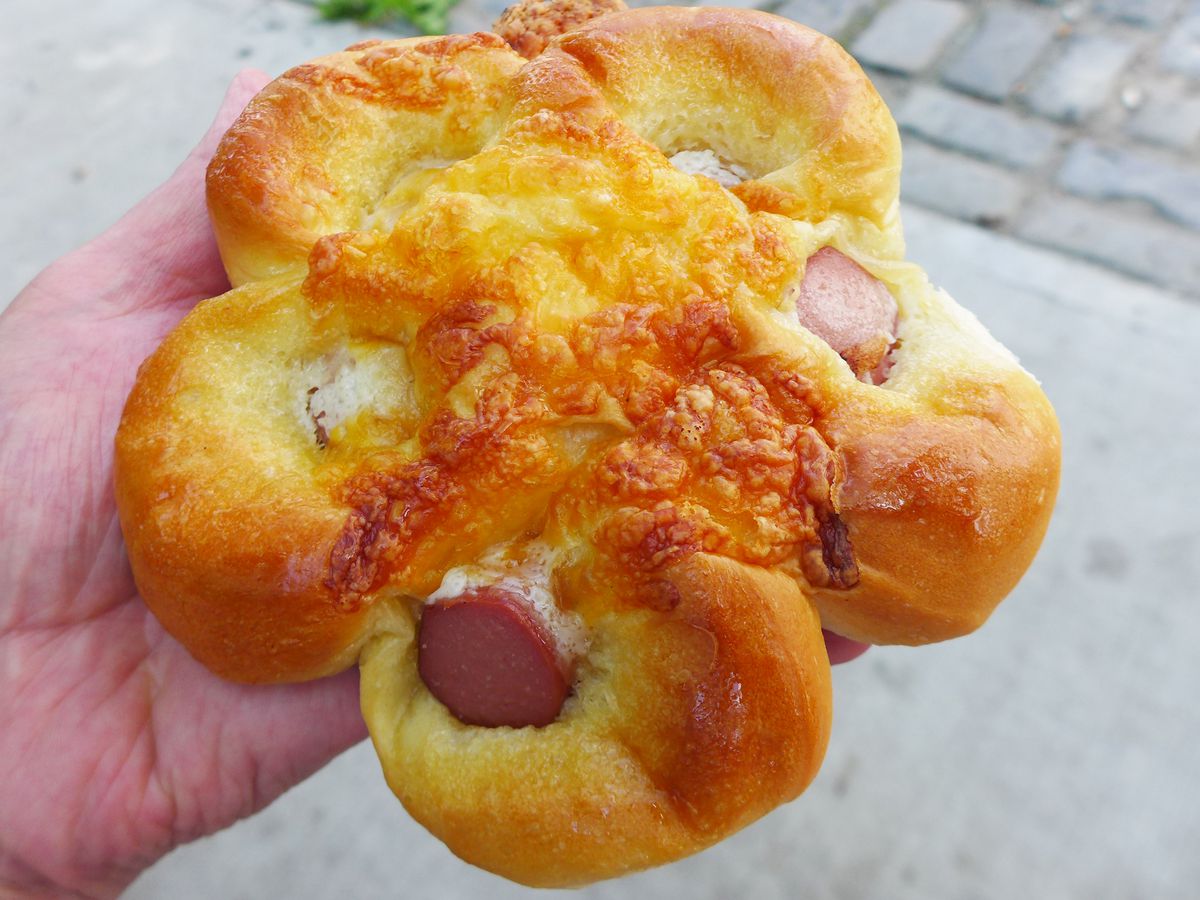 A pastry with five petals, with a hot dog segment in the middle of each one.