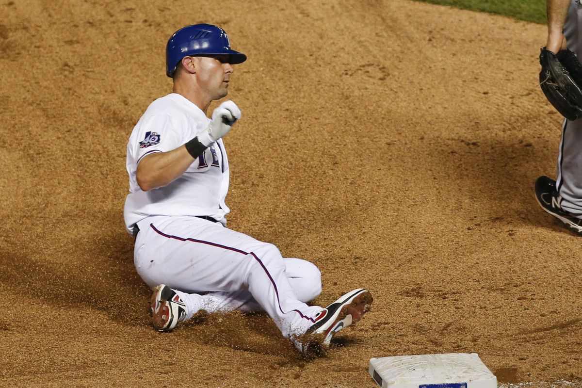 July 28, 2012; Arlington, TX, USA; Texas Rangers designated hitter Michael Young (10) slides to third base for a triple against the Chicago White Sox in the seventh inning at Rangers Ballpark in Arlington. Mandatory Credit: Jim Cowsert-US PRESSWIRE