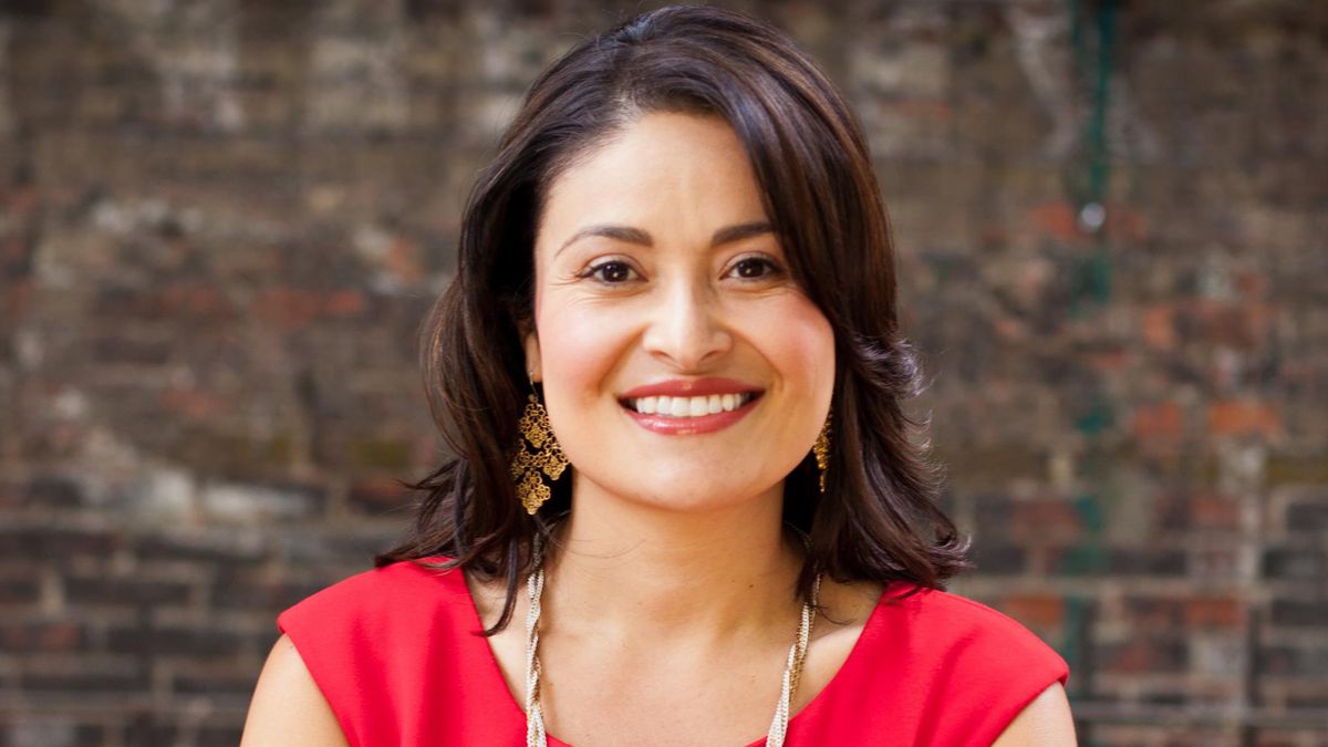 A portrait of Seattle City Council President Lorena Gonzalez wearing a red dress