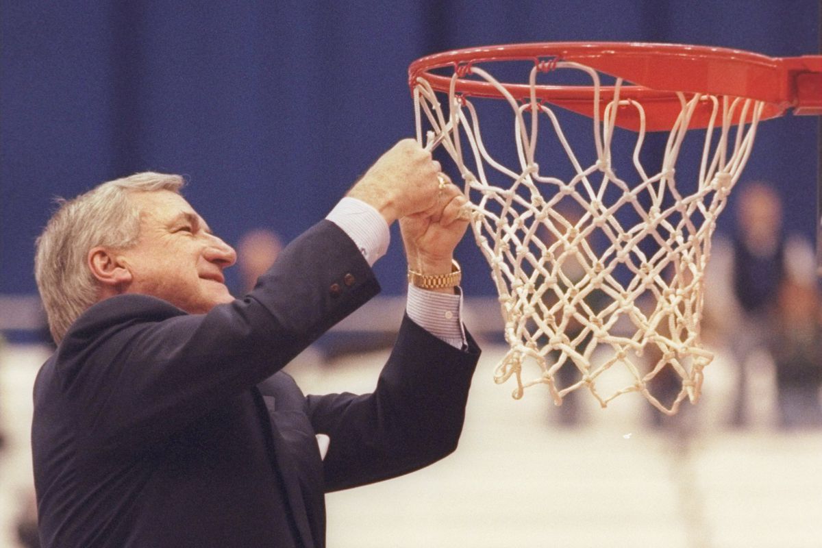 23 Mar 1997: Coach Dean Smith of the North Carolina Tarheels cuts the net after a playoff game against the Louisville Cardinals at the Carrier Dome in Syracuse, New York. The Tarheels won the game 97 - 74.