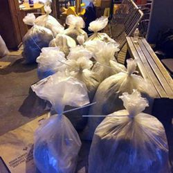 In this undated photo provided by the New York City Police Department, bags of loose marijuana sit on the floor of a warehouse in New York. Police say that they foiled a marijuana distribution ring that made about $10 million a year after detectives followed two men who picked up a container with about 300 pounds of marijuana from a freight warehouse in the Brooklyn borough of New York on Wednesday, March 9, 2016. (New York City Police Department via AP)