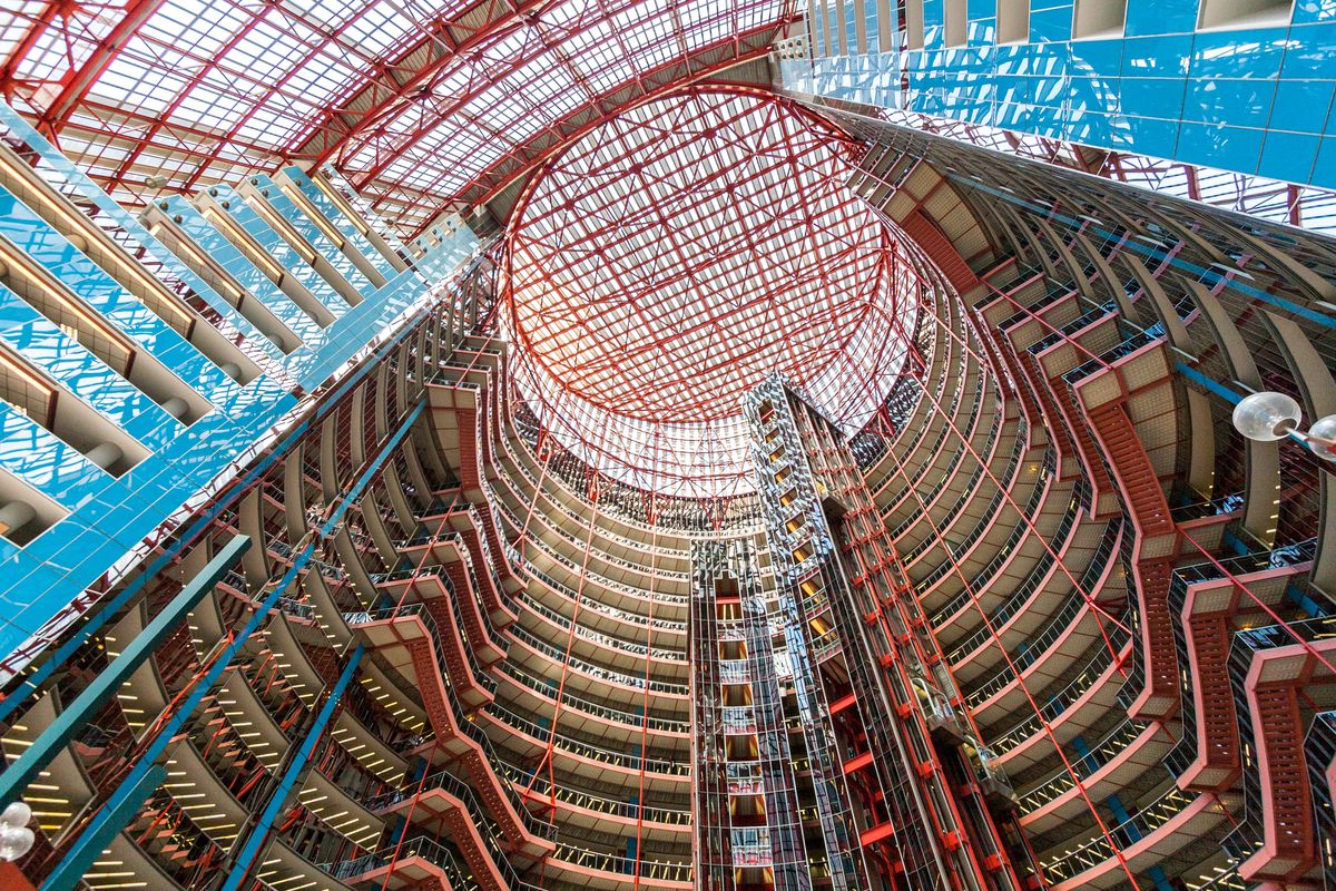 The interior of the James R. Thompson Center. The walls have colorful steel support beams and glass.