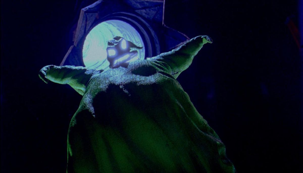 Oogie Boogie looming tall with his eyes and mouth glowing in The Nightmare Before Christmas.