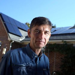 Jim French, who installed his first set of solar panels five years ago and recently added more panels, poses for a photograph at his home in Salt Lake City on Thursday, Aug. 28, 2014.