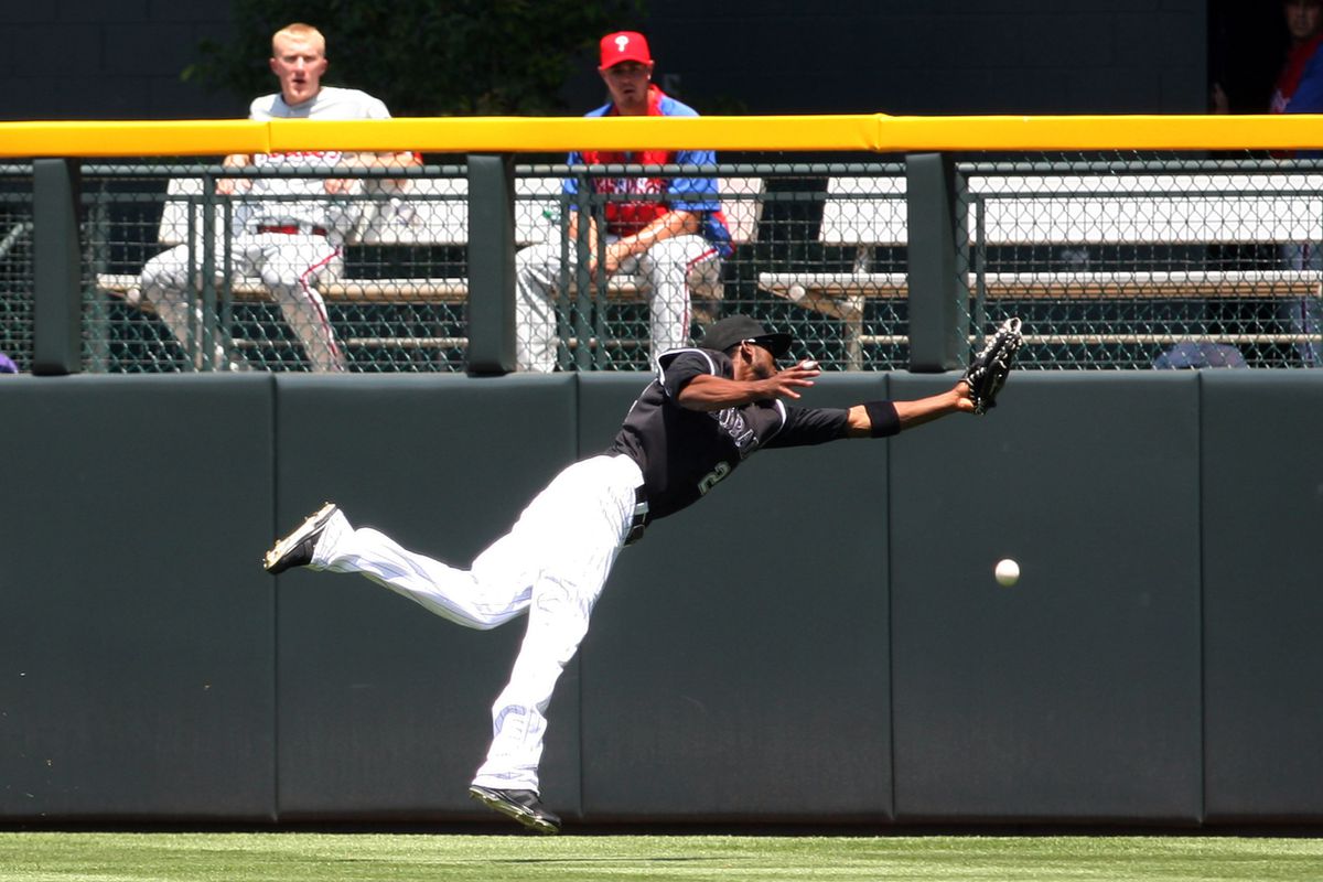 July 15, 2012; Denver, CO, USA; Colorado Rockies center fielder Dexter  Fowler (24) fails to catch a fly ball during the first inning against the Philadelphia Phillies at Coors Field.  Mandatory Credit: Chris Humphreys-US PRESSWIRE