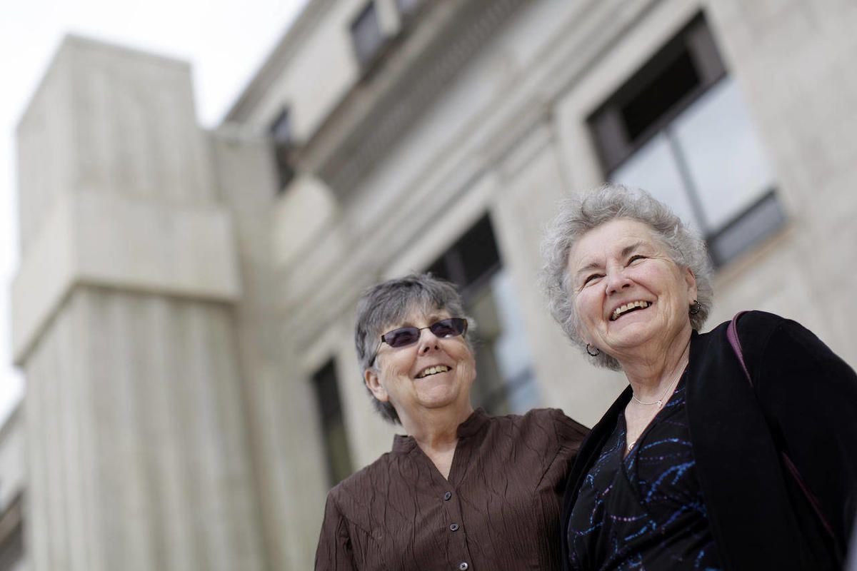 In this March 10, 2014 photo, Jennie Rosenkranz, 72, left, and Nancy Robrahn, 68, stand outside of the Pennington County Courthouse in Rapid City, S.D. The lesbian couple plans to exchange vows Saturday, April 26, 2014, in Minnesota, then be the first Sou
