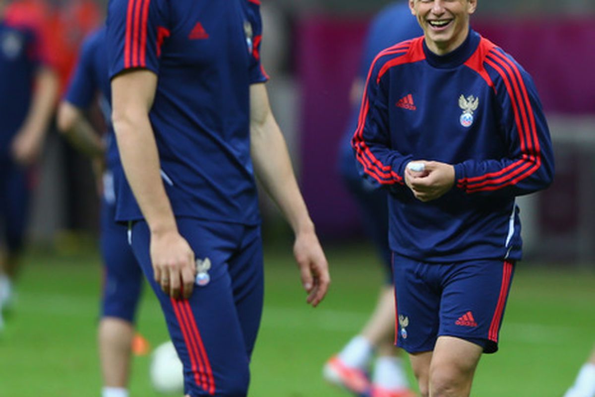 WARSAW, POLAND - JUNE 11: Andrey Arshavin (R) shares a joke with Pavel Pogrebnyak (L) of Russia during a UEFA EURO 2012 training session at the National Stadium on June 11, 2012 in Warsaw, Poland.