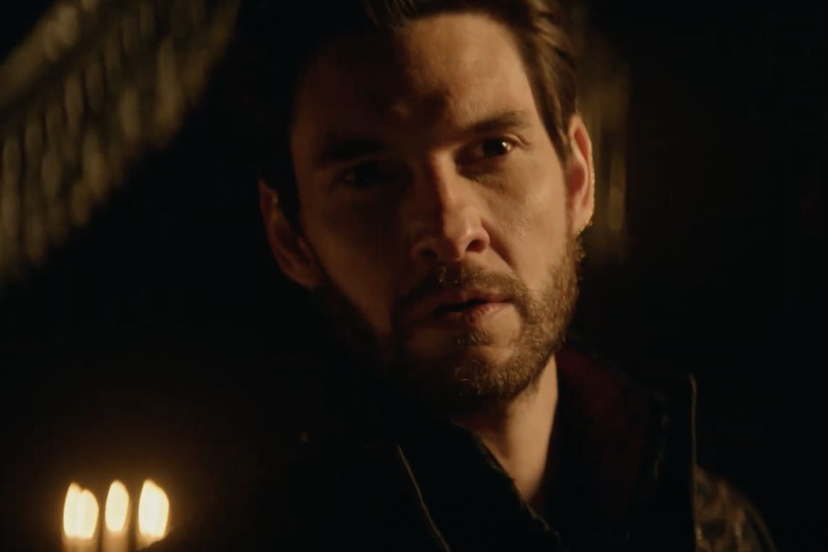 Ben Barnes doing that sexy mouth slightly open gaze things surrounded by candles in a dark room in Shadow and Bone season 2