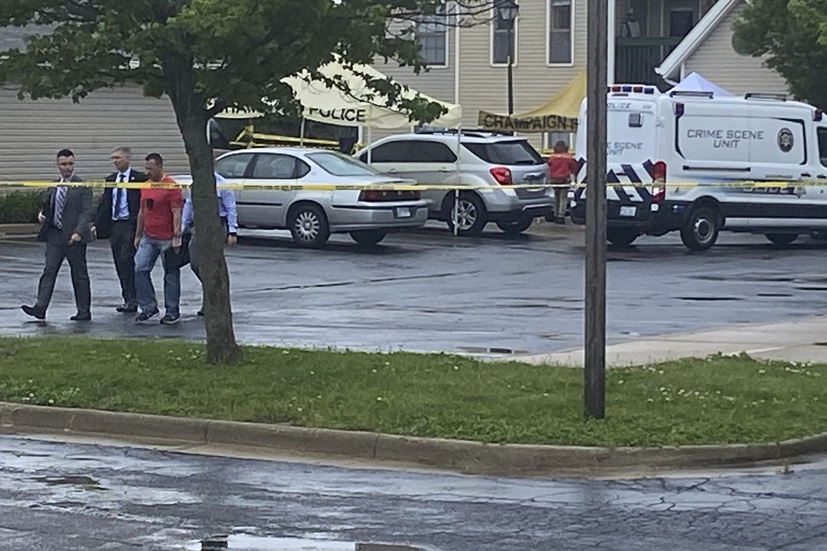 Police investigators work at the scene of a shooting in Champaign, Ill., Wednesday, May 19, 2021. 