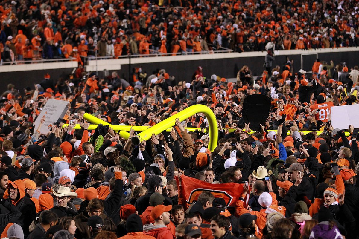 STILLWATER, OK - DECEMBER 03:  Oklahoma State Cowboys fans carry the goal post after a 44-10 win against the Oklahoma Sooners at Boone Pickens Stadium on December 3, 2011 in Stillwater, Oklahoma.  (Photo by Ronald Martinez/Getty Images)