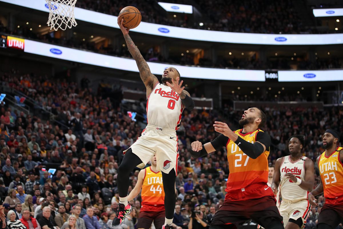 Portland Trail Blazers guard Damian Lillard lays the ball up to the basket after getting past Utah Jazz center Rudy Gobert during the first quarter at Vivint Smart Home Arena.&nbsp;