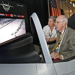 Sen. Bob Bennett flies an F-35 simulator with the help of pilot instructor Joe Parish as Alliant Techsystems has a ribbon-cutting and machine demo of the first fiber-placement machine used to make composites for the F-35 Lightning stealth fighter jet, Thursday, July 8, 2010, in Clearfield.