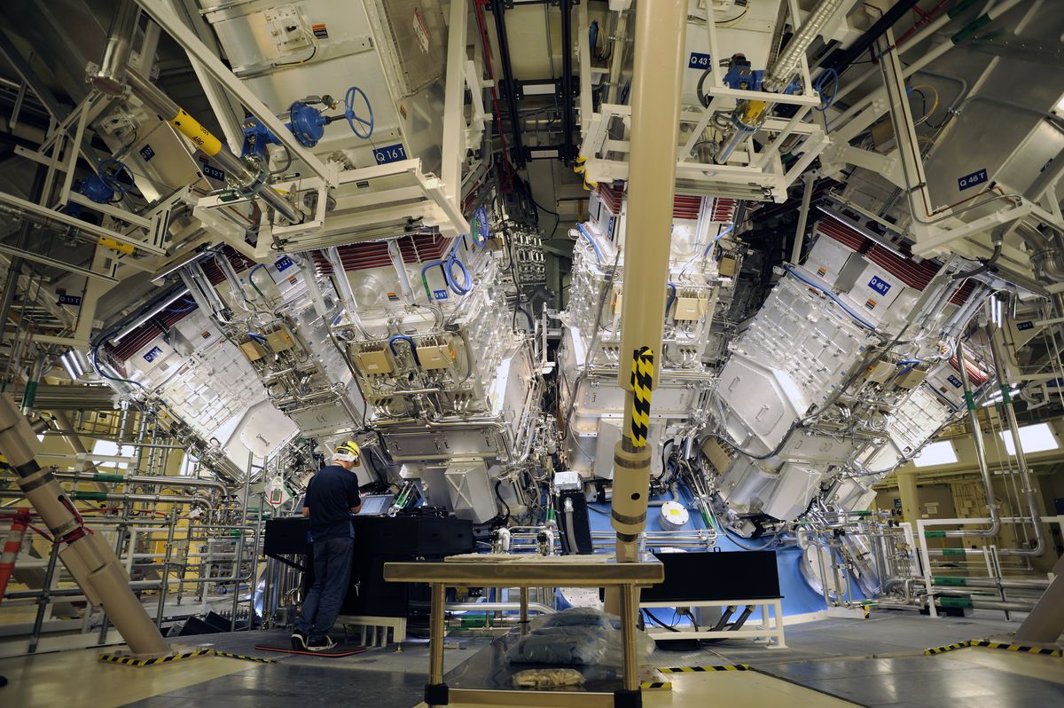 Engineers work outside the target chamber where the array of lasers at the National Ignition Facility at Lawrence Livermore Laboratory are focused. 