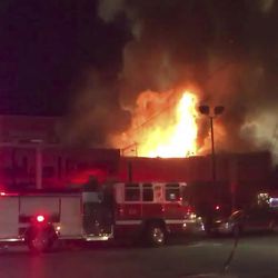 This photo taken from video provided by @Oaklandfirelive shows the scene of a fire in Oakland, early Saturday, Dec. 3, 2016.   The blaze began at about 11:30 p.m. on Friday during a party at a warehouse in the San Francisco Bay Area city.  Several people were unaccounted for.   Oakland Fire Department posted several messages throughout the night on its Twitter social media network account, including the latest one in the morning saying that fire crews would remain on the scene for several more hours to extinguish hot spots(@Oaklandfirelive via AP)